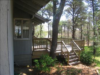 Back side of home with larger deck