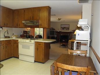 Kitchen to den view, 3 season room off den with sliders - also garage entry