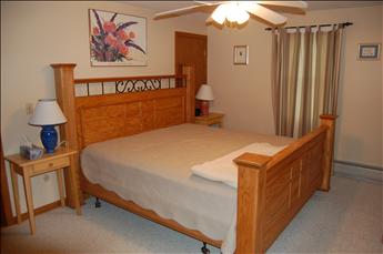 Master bedroom with King bed and bathroom with stall shower