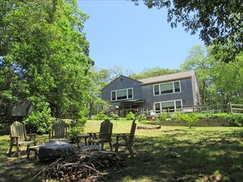 View from Pond of Back Yard with Firepit and Deck