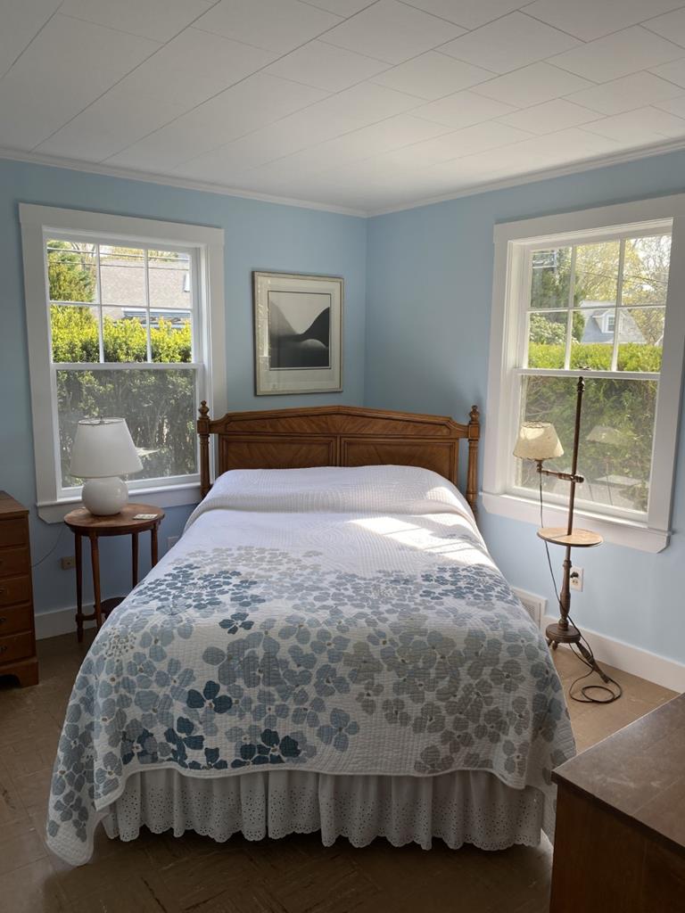 Light blue bedroom with window AC