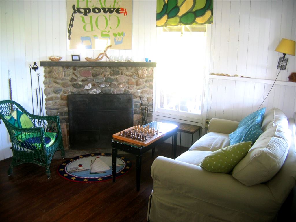 seating area in original cottage with stone fireplace