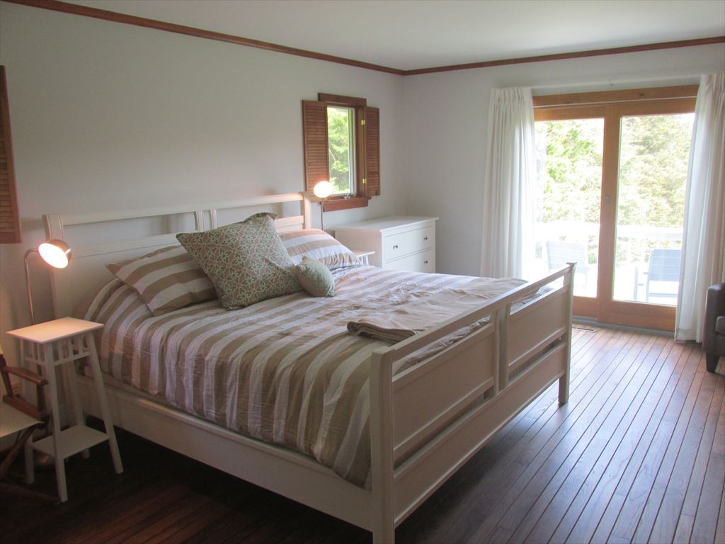 King bedroom with sliders to private deck
