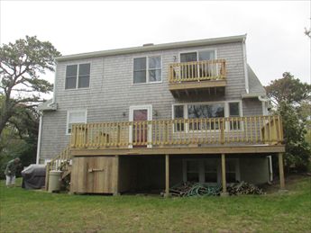 Back of house with large deck and 2nd floor balcony