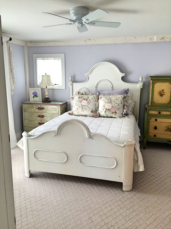 Primary bedroom with queen bed and attached bath on main level