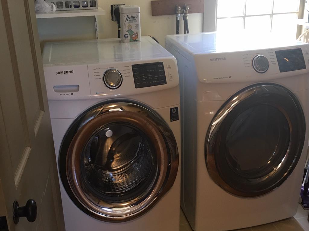 Enclosed laundry area with new washer/dryer